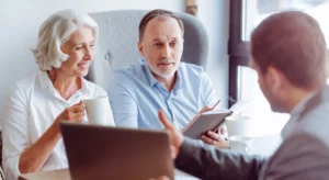 Couple de seniors en discussion avec un conseiller pour contrat obsèques.